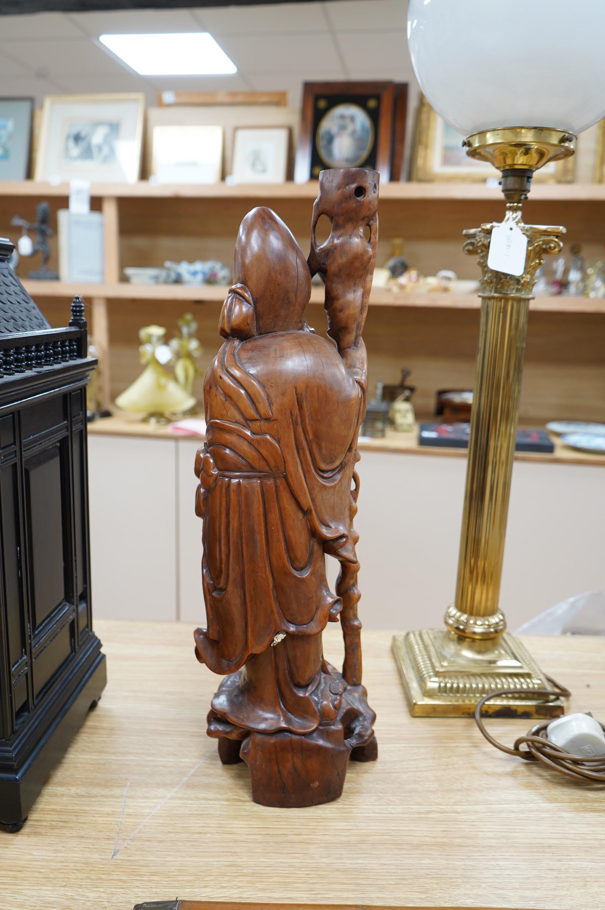 An early 20th century Chinese carved hardwood figure of Shou Lao, mounted as a lamp base, 55cm high. Condition - good